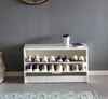 A white shoe cabinet filled with various shoes, placed against a gray wall. Náhled obrázku produktu