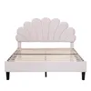 A white upholstered bed frame with a scalloped headboard and wooden slats for mattress support, shown against a white background. Produktbild-Vorschau