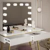 A white vanity table with a lighted mirror, drawers, and decorative busts. Náhled obrázku produktu