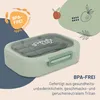 A light green lunchbox with a transparent lid, containing cutlery, is placed on a light beige background with decorative elements like leaves and fruit illustrations. Produktbild-Vorschau