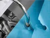 A close-up view of transparent hole reinforcement rings being applied to a blue sheet of paper with a metal tool. Produktbild-Vorschau