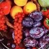 A close-up view of a variety of fresh fruits, including red currants, plums, apricots, and strawberries, arranged in a basket. Produktbild-Vorschau