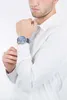 A man wearing a white shirt and a watch. Náhled obrázku produktu