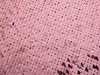 A close-up view of pink sequins on fabric. Produktbild-Vorschau