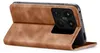 A brown leather flip case for a smartphone is shown standing open, revealing the phone's camera module. Produktbild-Vorschau