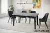 A dining room scene with a table and chairs, set on a rug. Produktbild-Vorschau