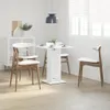 A dining set with a white table and chairs in a bright, modern room. Podgląd zdjęcia produktu