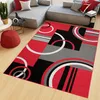 A modern living room with a sectional sofa and a geometric rug.