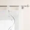 A close-up view of a white sheer curtain with decorative gray wavy lines and beads, hanging from a silver curtain rod with a decorative antler finial. Produktbild-Vorschau