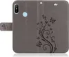A grey flip case for a Xiaomi Redmi Note 8 Pro phone, decorated with a floral and butterfly pattern. Produktbild-Vorschau