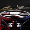 Close-up of a racing steering wheel with a blurred background of lights. Produktbild-Vorschau