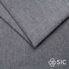 A close-up view of gray fabric, folded to show texture and depth. A logo is visible in the bottom right corner. Voir les images du produit