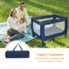 A family is having a picnic on the grass with a baby playpen next to them. Anteprima dell’immagine prodotto