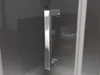 A close-up of a chrome shower door handle against a dark, reflective background. Produktbild-Vorschau