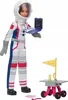 A Barbie astronaut doll holding a laptop, with a small rover and flag accessory. Produktbild-Vorschau
