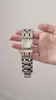 A hand holding a silver Guess watch. Produktbild-Vorschau