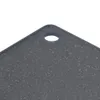 A close-up view of the corner of a speckled black cutting board with a hanging hole. Anteprima dell’immagine prodotto