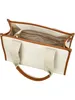 An open white canvas tote bag with brown leather trim and handles, viewed from a top-down angle. Anteprima dell’immagine prodotto