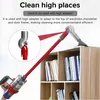 A person is using a red vacuum cleaner with an adapter to clean the top of a bookshelf. Náhled obrázku produktu