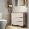 A bathroom setting with a toilet, a small shelving unit, and a fabric drawer unit. Podgląd zdjęcia produktu
