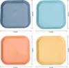 Four square plates in different colors arranged in a 2x2 grid. Produktbild-Vorschau