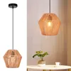 A pendant light fixture with a woven rattan shade is shown against a plain background, with a separate image showing the fixture hanging above a table with a plant and a cup. Produktbild-Vorschau