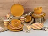 A collection of orange and yellow ceramic dishes and mugs with red and yellow striped patterns, arranged on a burlap cloth and a stone block against a wooden background. Náhľad obrázku produktu