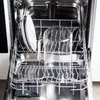 An open dishwasher with dishes and a glass pitcher inside. Produktbild-Vorschau