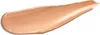A swatch of liquid foundation or BB cream is shown on a white background. Voir les images du produit