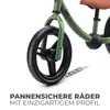 Close-up of a green balance bike's front wheel and fork, with text overlay. Produktbild-Vorschau