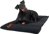A black and tan dog lying on a black dog bed. Produktbild-Vorschau
