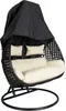 A black hanging egg chair with cream cushions and a black cover draped over the top, on a white background. Produktbild-Vorschau