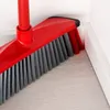 A close-up of a red and gray broom head cleaning a corner where the floor meets the wall. Anteprima dell’immagine prodotto