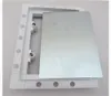 A white plastic frame with a silver metal plate inside, shown from a slightly elevated angle. Produktbild-Vorschau