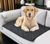 A golden retriever dog is lying on a gray pet training pad placed on a sofa. Náhľad obrázku produktu
