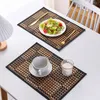Two placemats on a white table, one with a salad and cutlery, the other with a cup and glass. Produktbild-Vorschau
