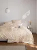 A neatly made bed with a duvet cover featuring a paisley pattern, set against a plain white wall. Produktbild-Vorschau