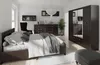A bedroom with a bed, dresser, and wardrobe. Podgląd zdjęcia produktu