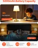 A collage of two lifestyle images showing a table lamp in use, with a child reading and a couple sleeping, and a row of feature icons at the bottom. Produktbild-Vorschau