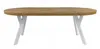 A product shot of an oval wooden table with white criss-cross legs, isolated on a white background. Náhled obrázku produktu