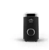 A black electric coffee grinder with a clear lid and silver accents, shown on a white surface with a subtle wood grain texture. Náhled obrázku produktu