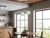 A modern dining room with a wooden table and chairs, large windows, and a pendant light fixture. Podgląd zdjęcia produktu