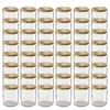 A grid of clear glass jars with gold lids. Voir les images du produit