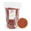 A bag of goji berries next to a bowl of goji berries. Náhľad obrázku produktu