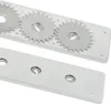 A close-up view of a metal grill component with gears and mounting holes. Produktbild-Vorschau