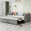 A light gray sofa bed is shown in a well-lit room with modern decor.