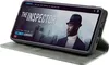A smartphone in a grey flip case is displayed, showing a movie poster on its screen. Produktbild-Vorschau