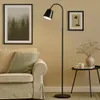 A modern living room scene with a floor lamp, sofa, and side table. Náhľad obrázku produktu