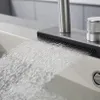 Water flowing from a modern faucet into a sink. Podgląd zdjęcia produktu