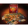 A board game setup with the game box in the background and the game board and pieces spread out on a textured surface. Náhľad obrázku produktu
